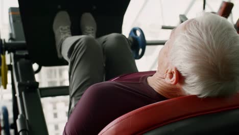 Elderly-Man-Doing-Exercise-on-Leg-Press-Machine