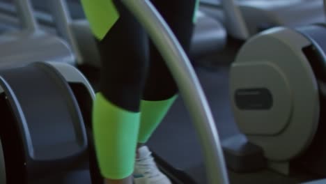 Unrecognizable-Woman-Using-Elliptical-Machine