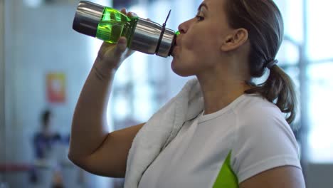 Tired-Woman-Drinking-Water-after-Workout