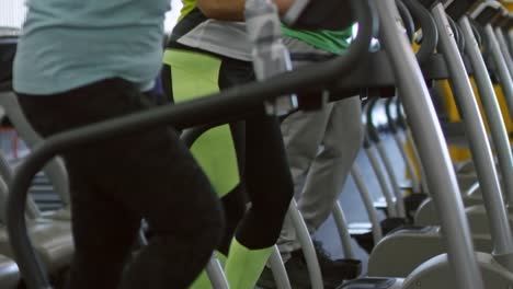 Cheerful-Women-Chatting-on-Stepper-Machines-in-Gym