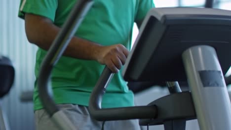 Unrecognizable-Man-Doing-Cardio-on-Elliptical-Machine