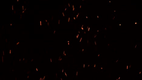 high-speed-shot-of-fire-flames-and-glowing-ash-particles-on-black-background