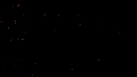 high-speed-shot-of-fire-flames-and-glowing-ash-particles-on-black-background