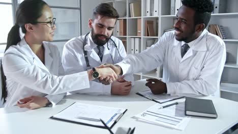 Young-Specialists-in-Lab-Coats-at-Meeting