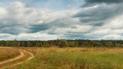 Panoramic-timelapse-of-autumn-landscapes,-rain-clouds-fly-over-field.