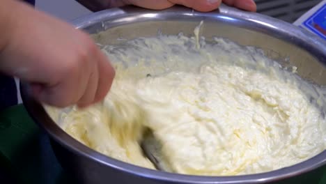 A-man's-hand-stirring-white-sauce.-The-chef-prepares-the-sauce-and-cheese.-Food.-Kitchen.-healthy-diet.-Close-up.-HD