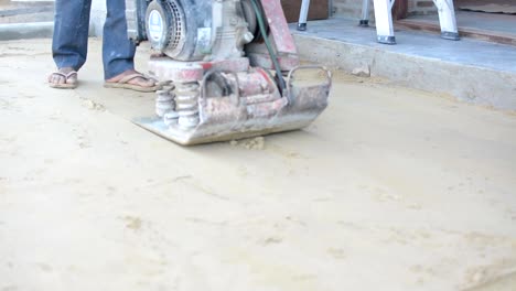 Worker-use-vibratory-plates-seals-the-base-sand