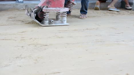 Worker-use-vibratory-plates-seals-the-base-sand