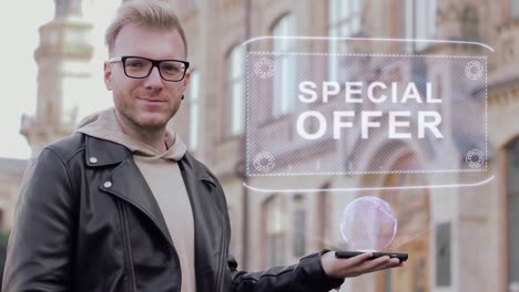 Smart-young-man-with-glasses-shows-a-conceptual-hologram-Special-offer