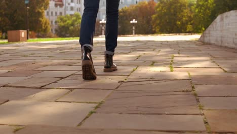 male-with-knapsack-use-smartphone-stroll-in-city