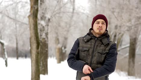 Young-man-waiting-for-someone-in-the-winter-city