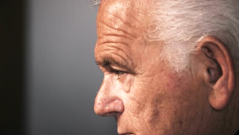 Profile-of-sad-old-man-raising-his-head