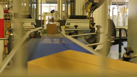 Folding-cardboard-boxes-on-a-conveyor-belt-in-a-rice-factory-–-4K