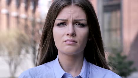 Portrait-of-Sad-Young-Woman-Looking-at-Camera