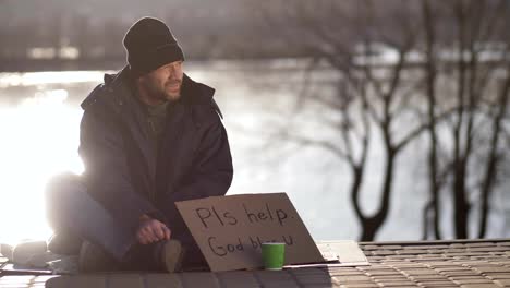 Female-sharing-hot-coffee-with-homeless-man