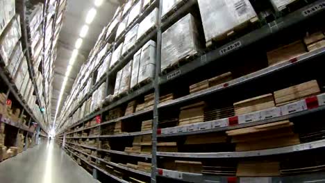4K-Time-Lapse-of-moving-between-palettes-with-cardboard-boxes-and-different-materials-in-a-storage-warehouse