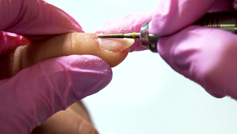 Beautician-careful-and-accurate-removing-cuticles-with-polish-machine