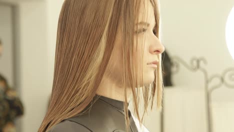 Face-young-woman-with-wet-hair-during-haircut-in-hairdressing-salon.-Close-up-female-hairdressing-in-beauty-studio