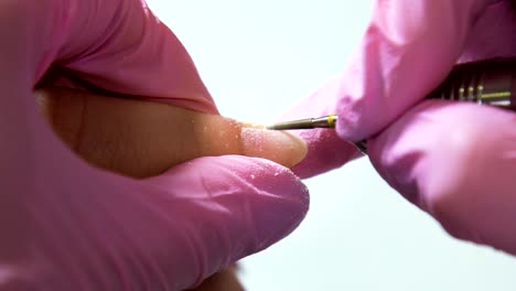 Beautician-careful-and-accurate-removing-cuticles-with-polish-machine