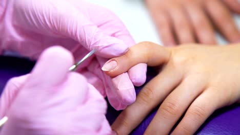 Beautician-careful-and-accurate-removing-cuticles-with-polish-machine