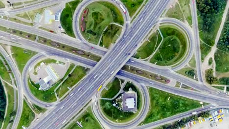 Static-vertical-top-down-aerial-view-of-traffic-on-freeway-interchange-at-night.-timelapse-background