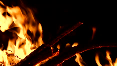 high-speed-shot-of-fire-flames-and-glowing-ash-particles-on-black-background