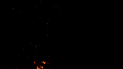 high-speed-shot-of-fire-flames-and-glowing-ash-particles-on-black-background