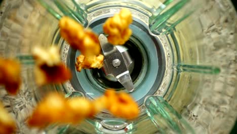 Falling-of-walnut-in-a-blender-bowl.-Slow-motion.	Top-view.