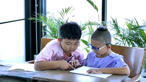 Asian-boy-two-people-with-writing-homework.-education-concept