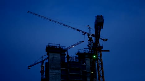 4K-footage.-crane-rotate-at-construction-site-in-the-dusk
