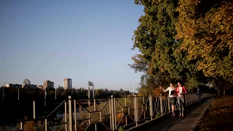 Two-women-with-the-drawings-are-on-the-waterfront-and-discuss-the-details-of-an-architectural-project.