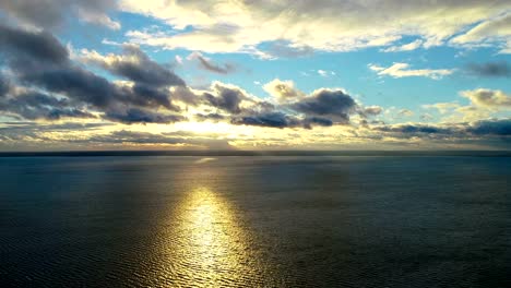 The-flight-above-the-sea-on-the-sunrise-background.-time-lapse