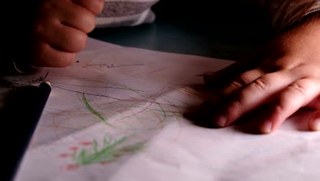 Little-child-draws-on-a-sheet-of-paper-with-pencils-and-felt-tip-pens,-learns-to-draw-on-a-piece-of-paper---home-education.