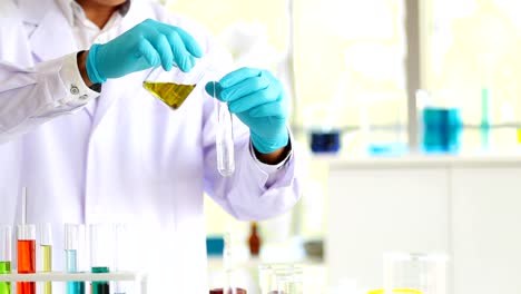 Closeup-man-laboratory-scientist-working-at-lab-with-test-tubes