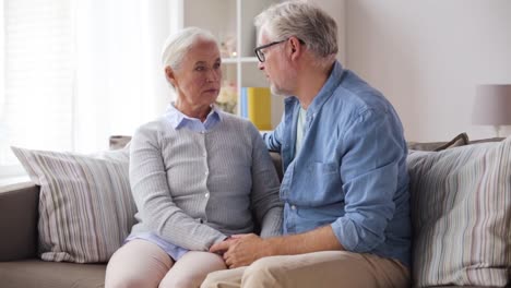 sad-senior-couple-hugging-at-home