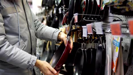 A-young-woman-chooses-a-non-stick-frying-pan-in-the-store.