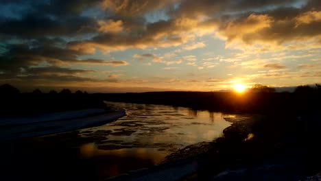 Winter-landscape-with-moving-ice-floes-and-clouds-at-sunset-timelapse-4K