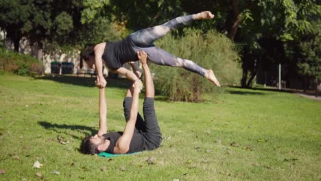 Beautiful-couple-practicing-acro-yoga-in-the-morning