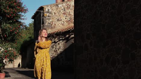 The-tourist-girl-walks-through-the-old-streets-in-rays-of-the-sun