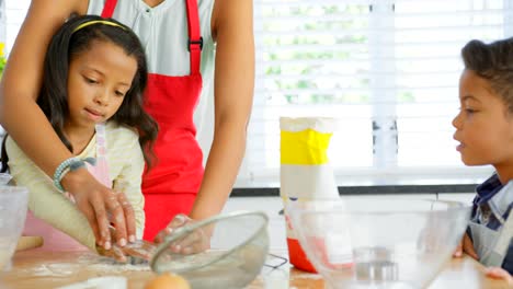 Black-mother-and-daughter-using-cookie-cutter-in-kitchen-4k