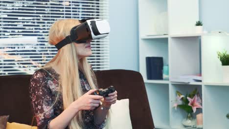 Close-up-of-attractive-woman-playing-a-game-with-joystick-in-virtual-reality-goggles-on-Christmas