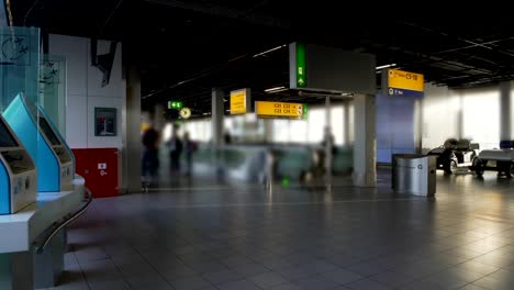 Airport-terminal,-passengers-with-luggage-walking-to-check-in-desk,-traveling