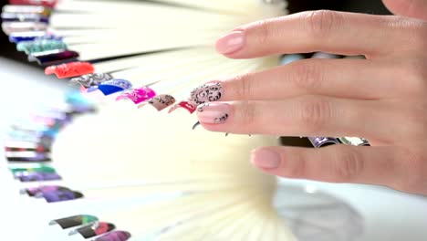 Woman-choice-of-nail-art-in-salon.