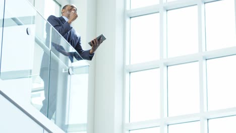 African-American-male-finance-executive-using-tablet-device