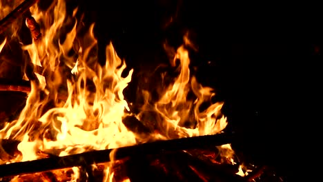 high-speed-shot-of-fire-flames-and-glowing-ash-particles-on-black-background