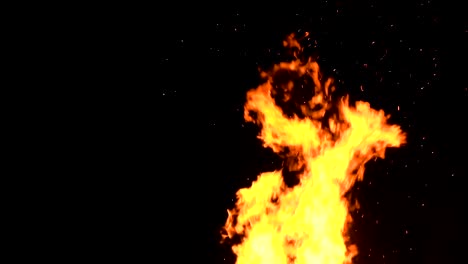 high-speed-shot-of-fire-flames-and-glowing-ash-particles-on-black-background