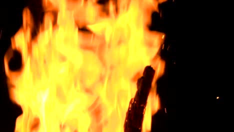 high-speed-shot-of-fire-flames-and-glowing-ash-particles-on-black-background