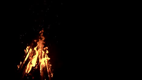 high-speed-shot-of-fire-flames-and-glowing-ash-particles-on-black-background