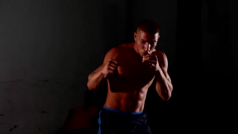 Male-muscular-topless-boxer-exercising-shadow-boxing.