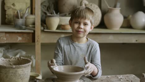 Boy-Posing-in-Pottery-Workshop